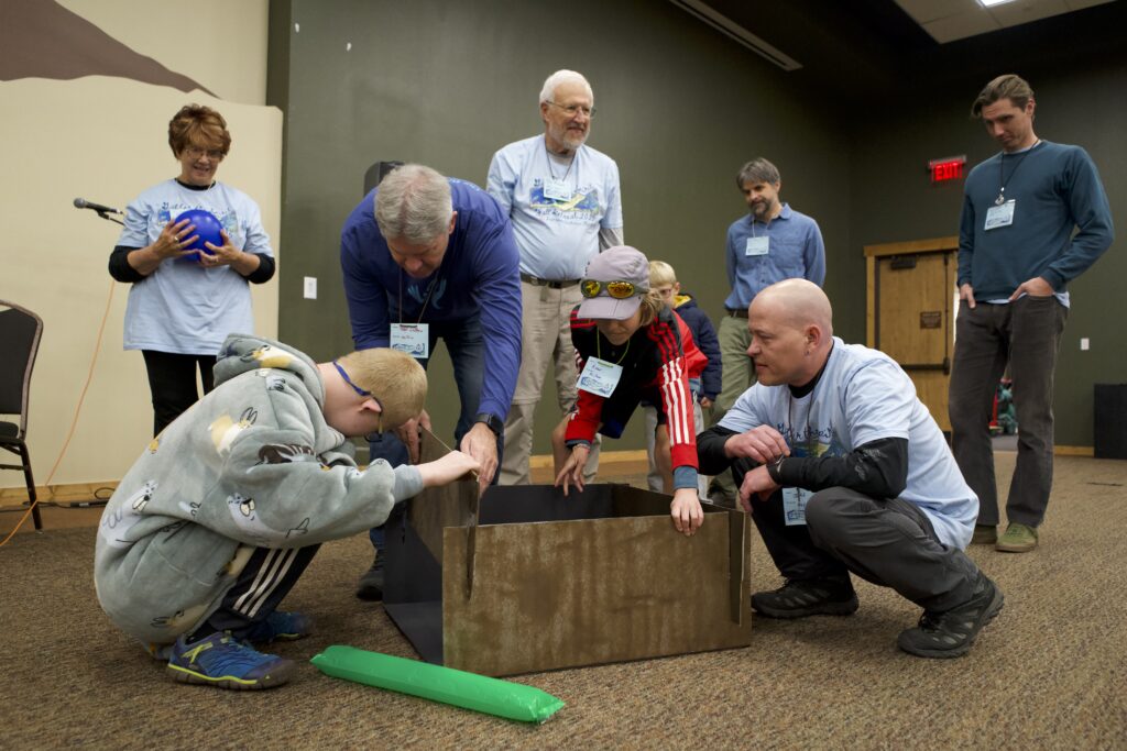 A few of our members participate in a chalice-building activity at our 2025 fall retreat at YMCA of the Rockies.
