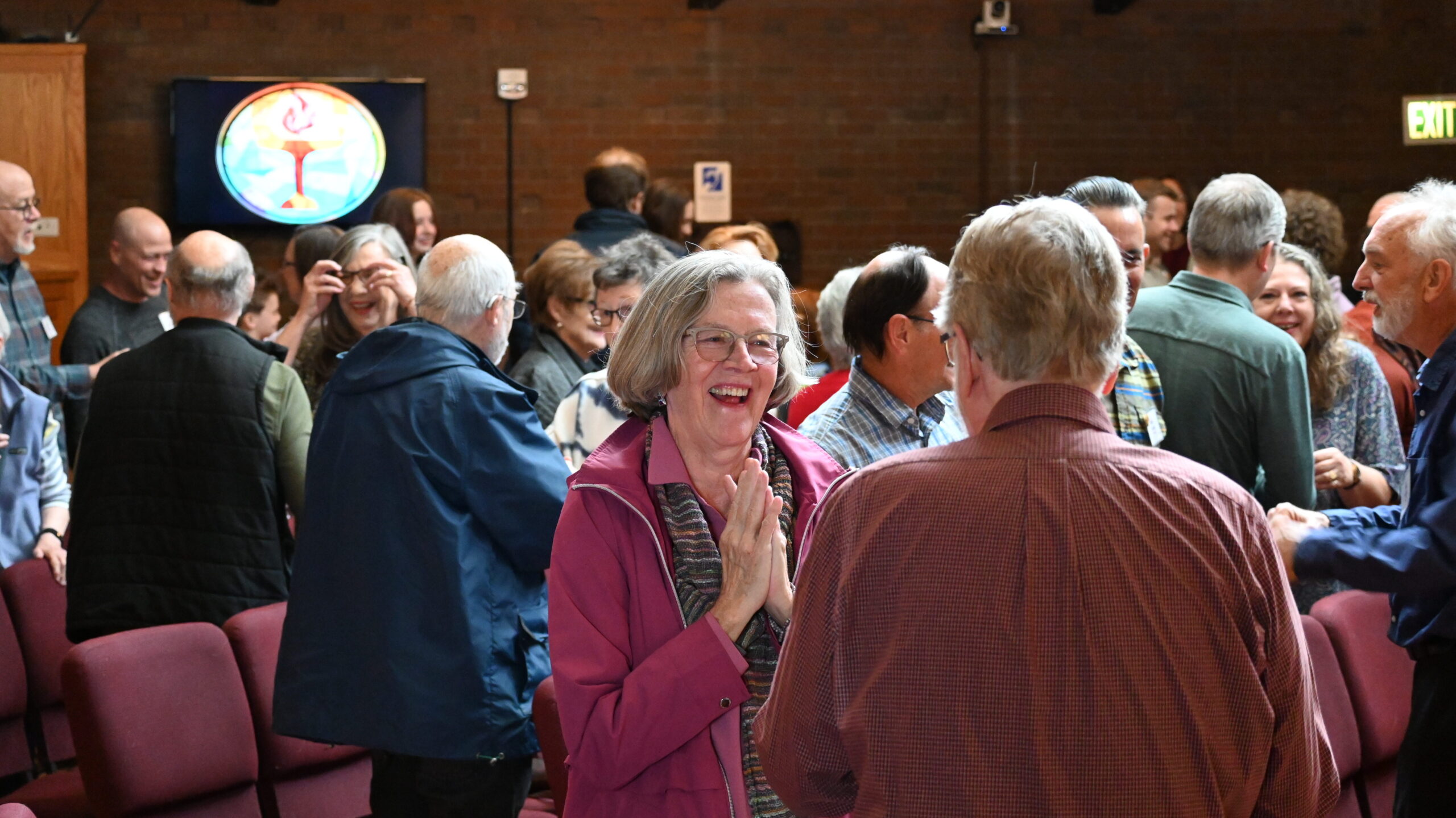 Common Flame members greet each other in the sanctuary during a Sunday service