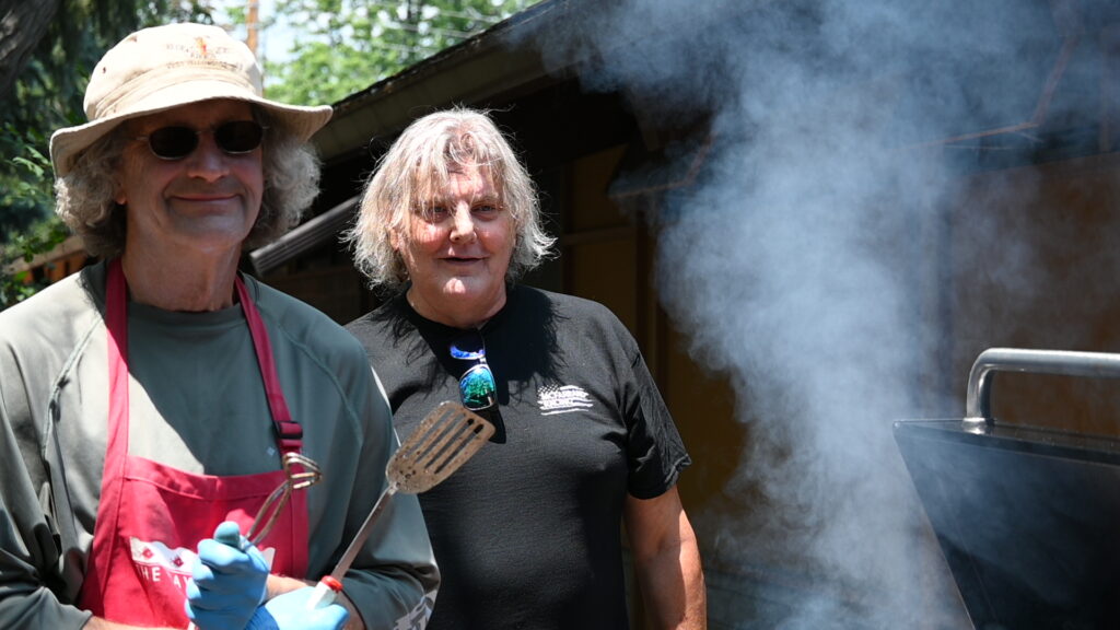 A couple of volunteers grilling up some burgers and hot dogs during our annual Golden Circle BBQ.