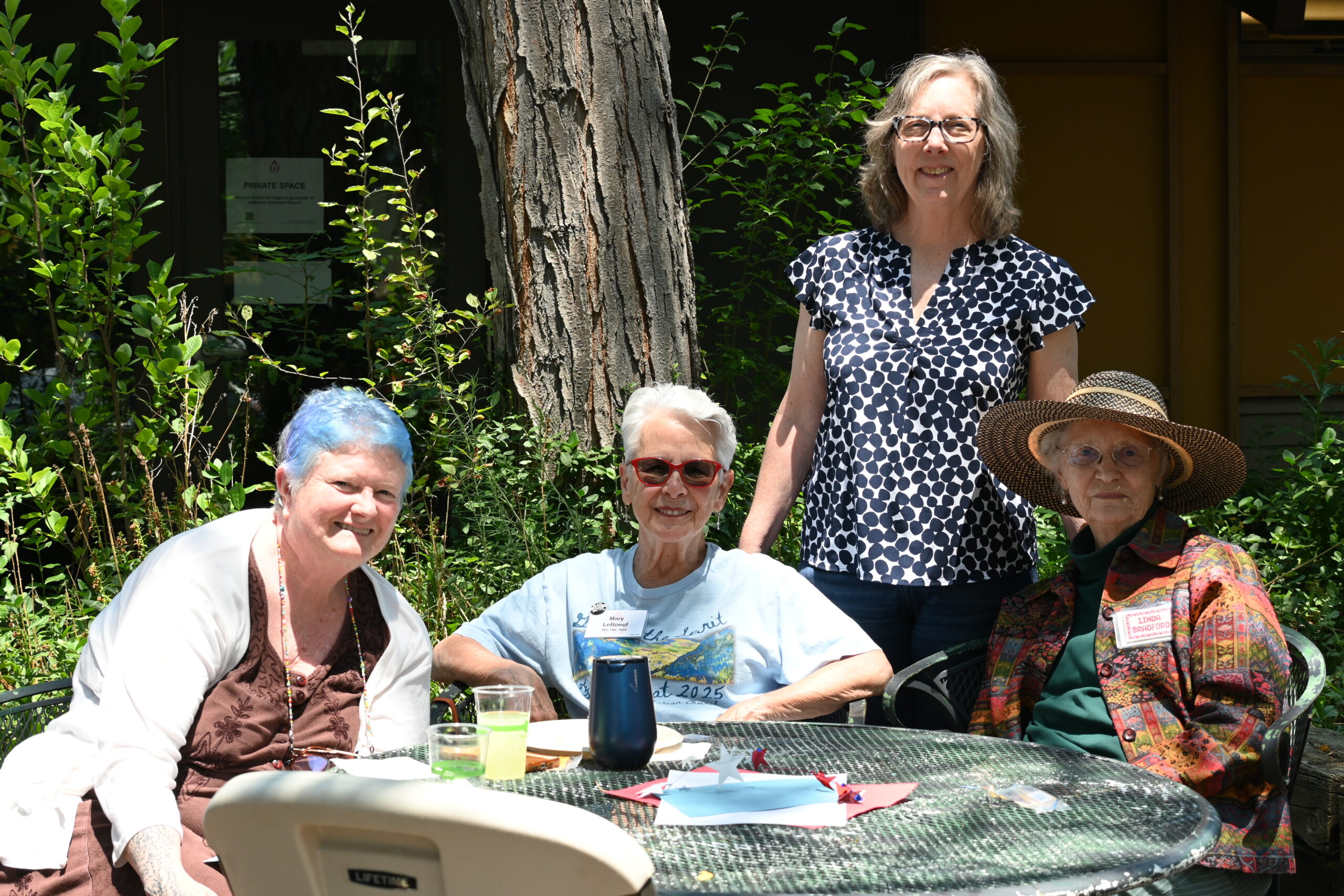 Four Common Flame members pose for a photo during our annual Golden circle summer BBQ out on the patio.